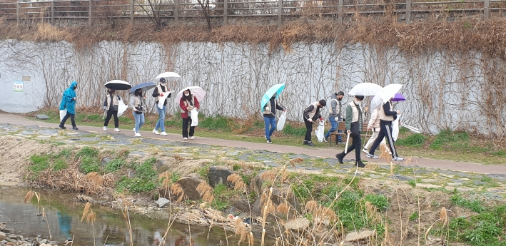 '세계 물의 날' 행사에 참석한 시민들이 수원천 주변의 쓰레기를 치우고 있다.