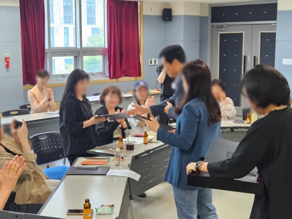 평생학습기획관이 수료생에게 수료증을 수여하고있다.