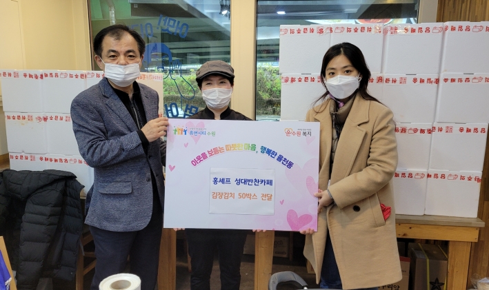 홍영남씨가 수원시 장안구 율천동 행정복지센터에 김치 50박스를 전달한 후 기념촬영을 하고 있다.