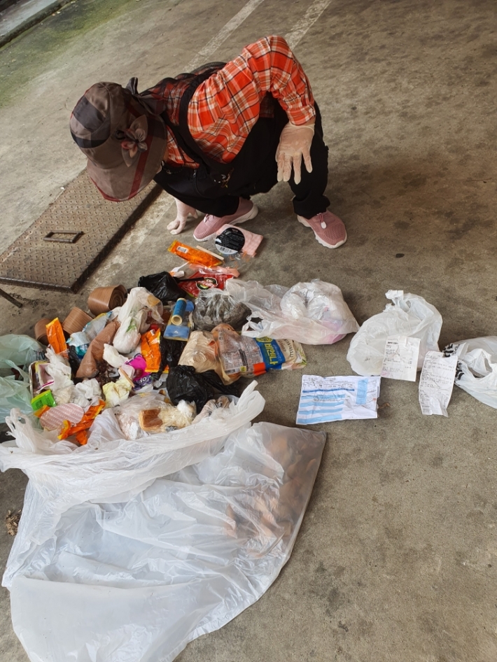 자원관리사가 무단배출된 쓰레기를 확인하고 있다.