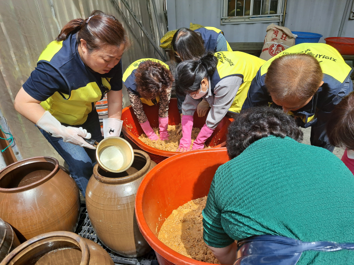 세류1동 지역사회보장협의체 위원들이 소외계층을 위한 장담그기 행사를 진행하는 모습이다.