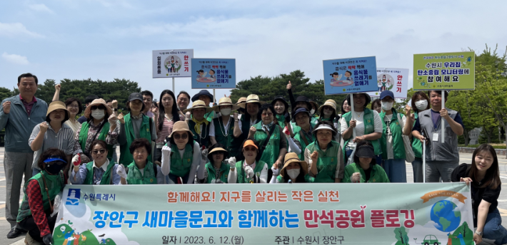 장안구 새마을문고회와 장안구 공직자가 함께 만석공원에서 플로깅 행사를 하고 있다.