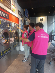 세류3동 지역사회보장협의체 위원이 이불을 수거하여 세탁서비스를 수행하고 있는 모습.