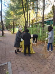 곡선동 통장협의회 회원들이 낙엽을 쓸어담고 있다.