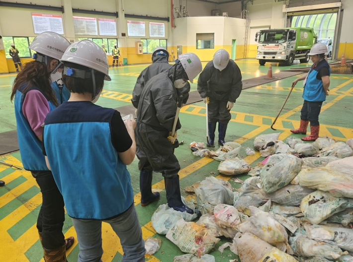 입북동 주민들과 통장들이 반입쓰레기 샘플링을 하고 있다.
