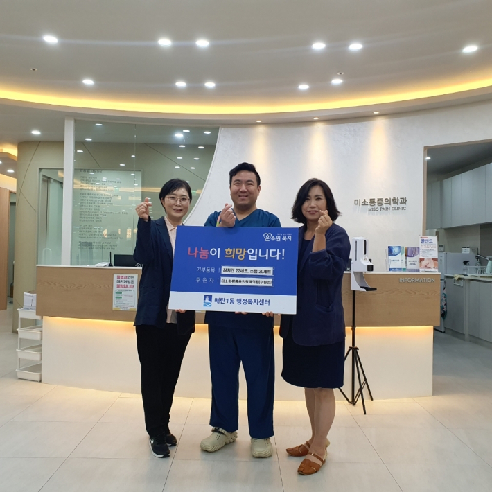미소마취통증의학과의원(원장 김승범)에서 매탄1동행정복지센터(동장 이기범)에 후원물품 42세트를 전달하고 기념사진을 촬영하고 있다. 