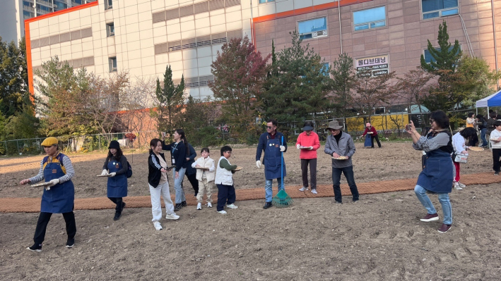 시민들이  청보리씨앗을 뿌리고 있다