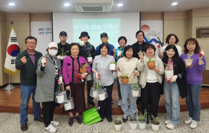 손바닥정원 교육에 참여한 주민들이 직점 만든 재활용 화분을 들고 환한 미소를 짓고 있다.