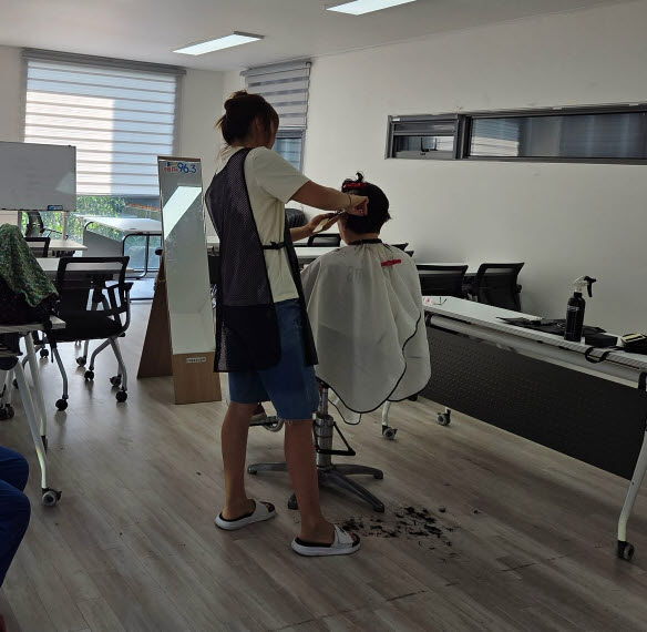 보민헤어 김보민 원장이 어르신들의 머리를 다듬어 주고 있다.