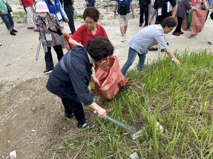 쓰레기를 주우며 환경정화 활동이 진행되고 있다.