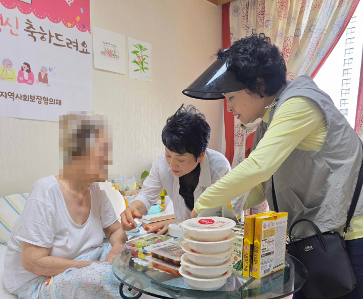 어르신에게 구급함 용도를 설명해드리고 있다