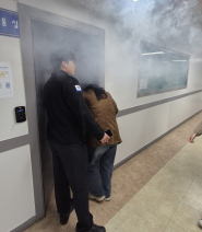 대피훈련을 진행하기 위해 연기가 가득한 실내로 들어가고 있다.