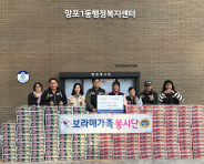 보라매가족봉사단이 100번째 나눔활동으로 망포1동에 컵라면 200박스를 후원하고 기념촬영을 하고 있다