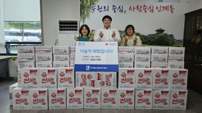 전달식 후 정재영 길림성 대표와 박선옥 인계동장이 기념촬영을 하고 있다