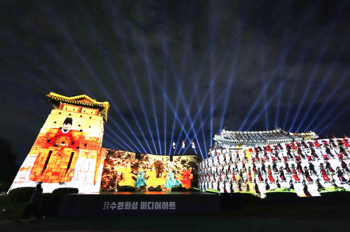 사진1·2) 화서문 성벽에 2025 수원화성 미디어아트 메인 작품인 '새빛 향연'이 상영되고 있다.    
