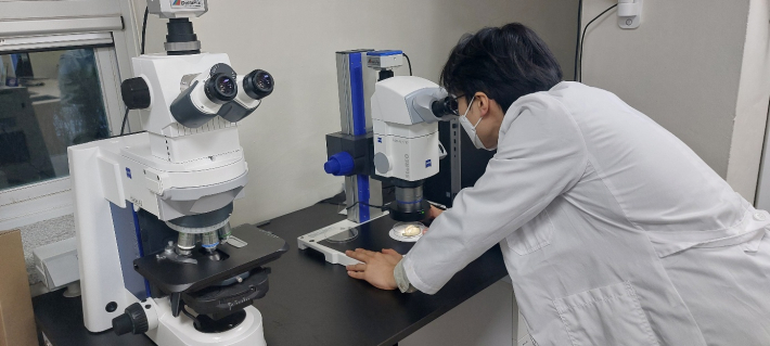 현미경으로 식물의 병충해를 관찰하고 있다.