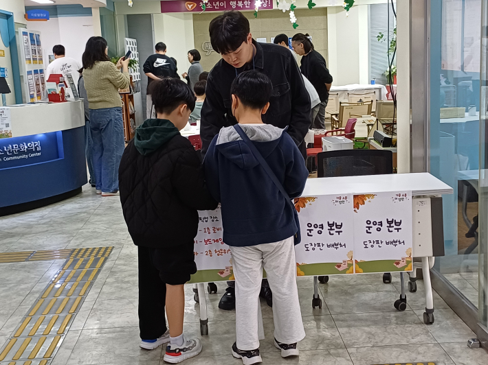 '가을소풍 IN 장안 스탬프 북' 카드를 받는 모습