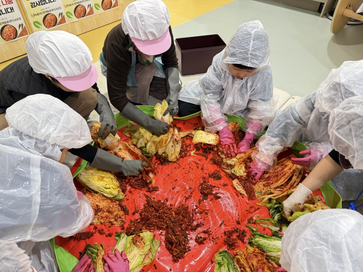 돌봄센터 아이들과 주민이 함께 김장김치를 만들고 하고 있다. 