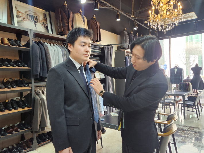 면접 정장을 착장한 본 기자에게 복장 관련 어드바이스를 해주고 있는 배경민 실장