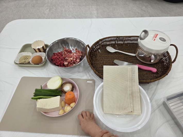 각 테이블에 두부, 채소, 고기 등 요리 재료와 조리 도구가 정갈하게 준비되어 있다.