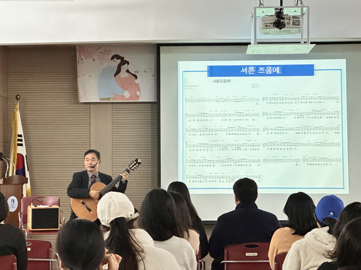 이병준 강사가 감미로운 연주와 함께 노래의 의미를 전달하며 관객들과 소통하고 있다.