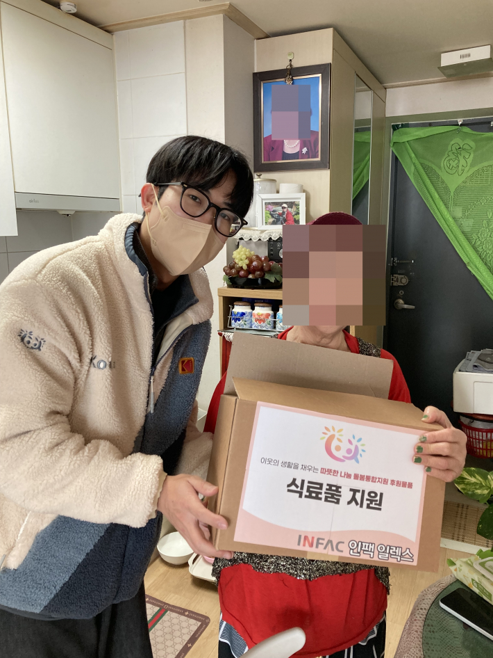 능실종합사회복지관 사회복지사가 지역주민의 가정을 방문해 식료품 꾸러미와 죽을 전달하고 있다.