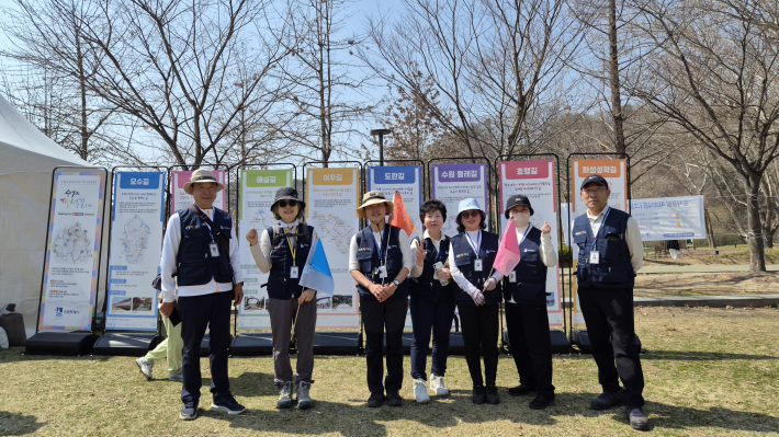 수원 팔색길 해설사들과 함께 팔색길을 소개하는 배너 앞에서 사진을 찍고 있다.