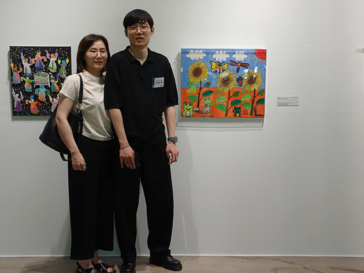 성인부 우수상을 밭은 유원재 작가의 어머니와 기념사진 장면  