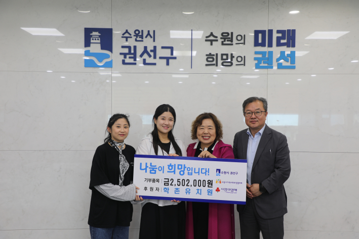 학촌유치원 원장과 교사 2명, 권선구청장이 '기부품목 금 2,502,000원'이라고 적힌 판넬을 들고 기념촬영을 하고 있다.